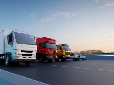 Commercial delivery vehicles in a row on the road. Fast delivery,cargo logistic and freight shipping concept. 3d rendering.