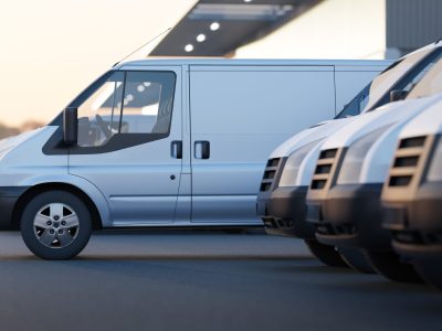 Delivery vans standing out from a fleet of white vans. Express delivery and shipment service concept. 3d rendering